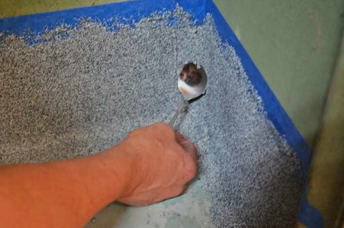 Apply pressure to the spoon. Move the spoon downward until the spoon reaches the bottom of the cove base corner
